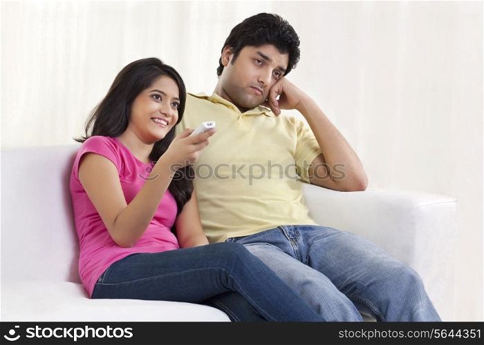 Young woman sitting with bored husband