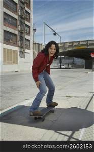 Young woman skateboarding at a roadside