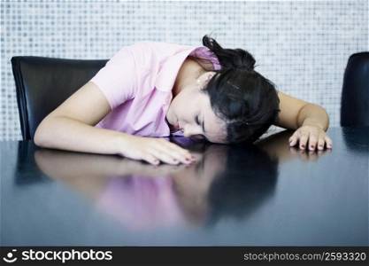 Young woman sleeping at a table