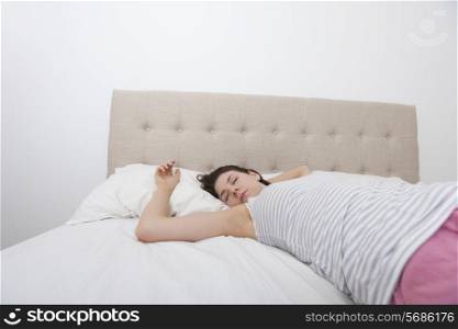 Young woman sleeping comfortably in bed