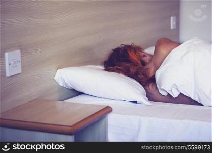 Young woman sleeping in hotel room