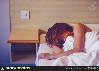 Young woman sleeping in hotel room