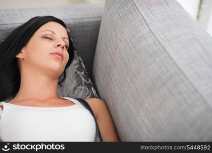 Young woman sleeping on divan