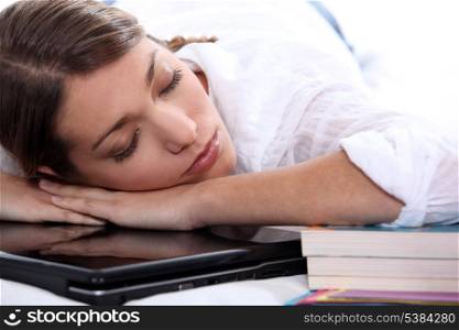young woman sleeping on her computer