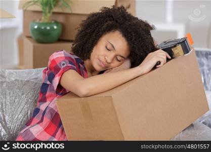 young woman sleeping on packing cases