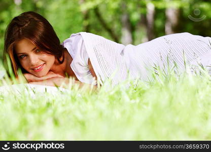 Young woman sleeping on soft pillow in fresh spring grass