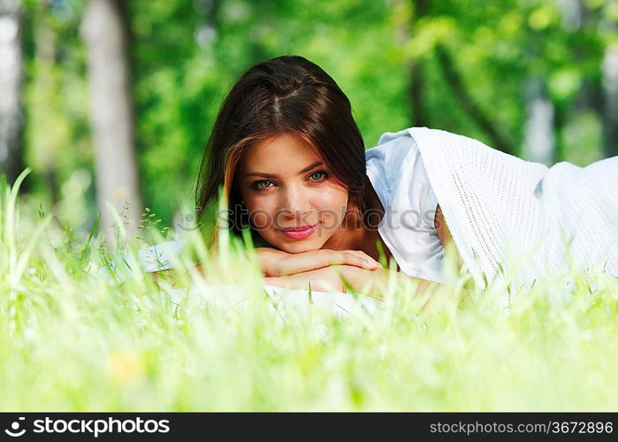 Young woman sleeping on soft pillow in fresh spring grass