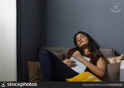 Young woman sleeping while reading a book