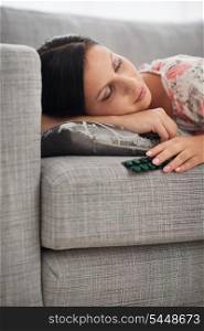 Young woman sleeping with pack of tablets