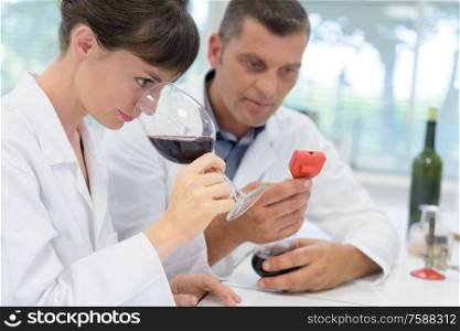 young woman smelling white wine aroma at tasting