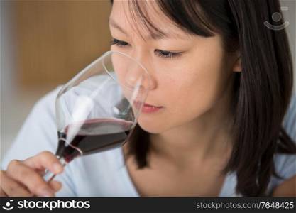 young woman smells the wine