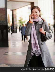 Young woman smiling and talking on a mobile phone