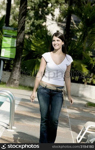 Young woman smiling and walking