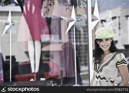 Young woman smiling in front of a clothing store