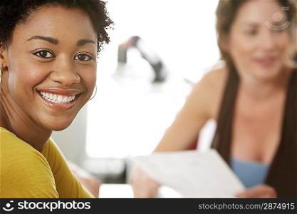 Young woman smiling in office meeting portrait