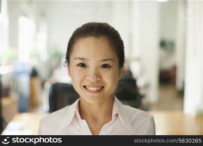 Young woman smiling in the office, portrait