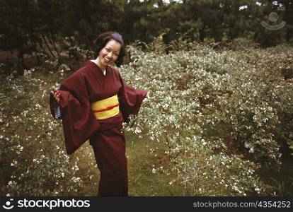 Young woman smiling in traditional Japanese clothing, Kamakura, Kanagawa Prefecture, Japan