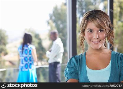 Young woman smiling indoors, portrait