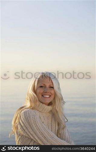Young woman smiling on beach, portrait