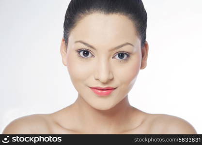 Young woman smiling over white background