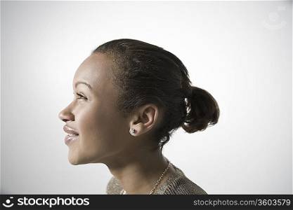 Young woman smiling, profile, close-up view