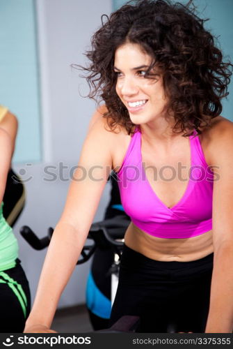 Young woman smiling while doing cardio exercise in a gym.