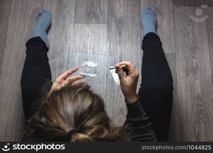 Young woman snorting drugs, cocaine or speed or other drugs abuse, addiction and depression. Young woman snorting drugs, cocaine or speed or other drugs abuse, addiction
