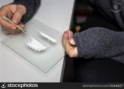Young woman snorting drugs, cocaine or speed or other drugs abuse, addiction and depression. Young woman snorting drugs, cocaine or speed or other drugs abuse, addiction