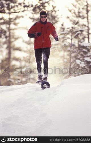 Young woman snowshoeing