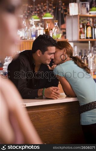 Young woman socializing with bartender, night