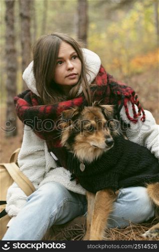 young woman spending time together with her dog outdoors