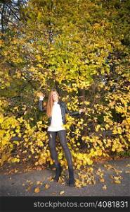 Young woman stand autumn leaves fall yellow green girl garden background