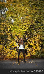 Young woman stand autumn leaves fall yellow green girl garden background