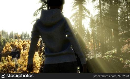 Young Woman standing alone outdoor with wild forest mountains