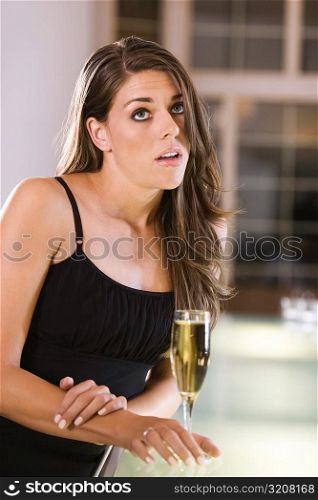 Young woman standing at a bar counter