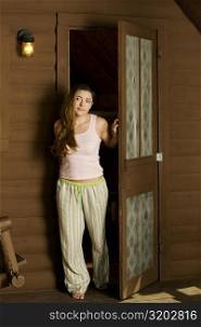 Young woman standing at the doorway