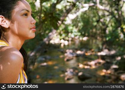 Young Woman Standing by Creek