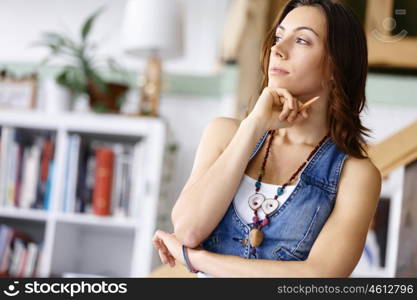 Young woman standing in creative office. Smiling young designer standing in creative office