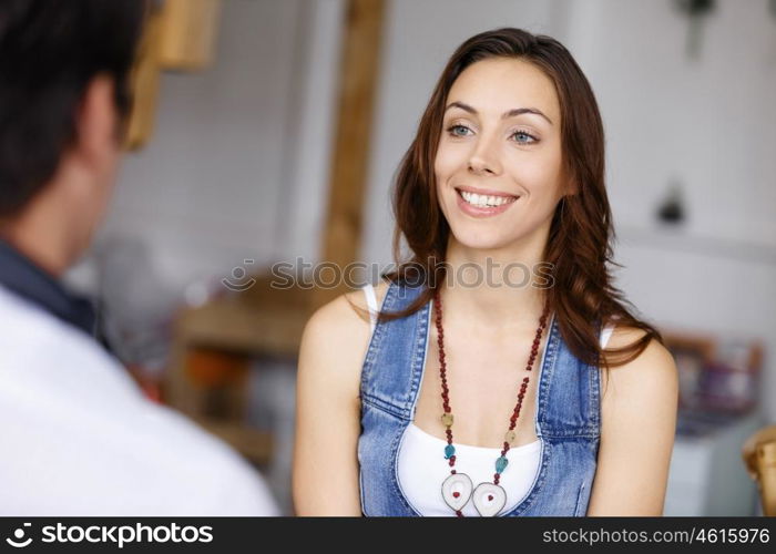 Young woman standing in creative office. Smiling young designer standing in creative office