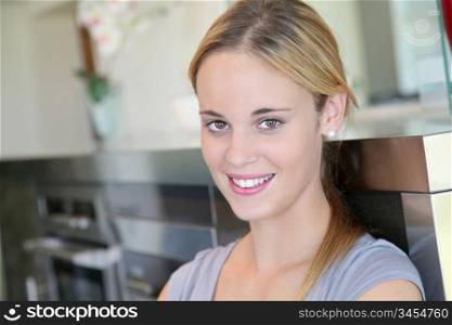 Young woman standing in kitchen