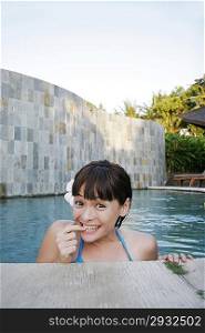 Young woman standing in swimming pool