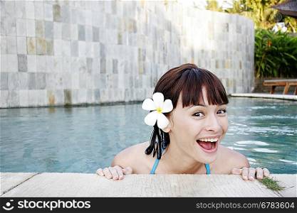 Young woman standing in swimming pool