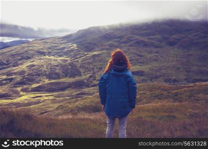 Young woman standing in the mountains