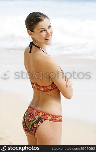 Young woman standing on the beach