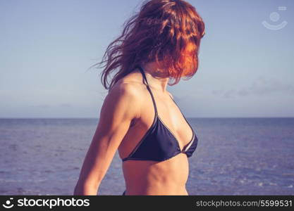 Young woman standing on the beach