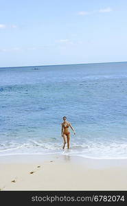 Young woman standing on the beach