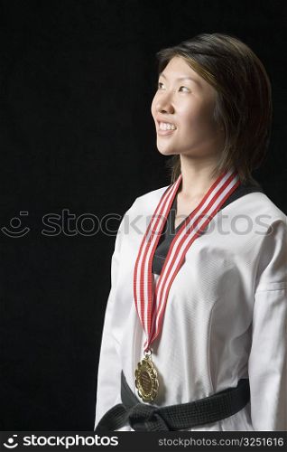 Young woman standing with a medal around her neck
