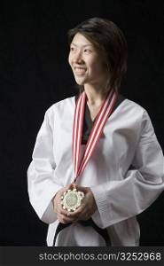 Young woman standing with a medal around her neck