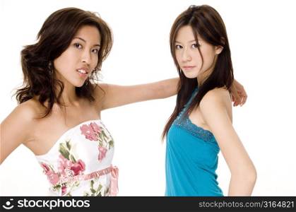 Young woman standing with her hand on another young woman&acute;s shoulder