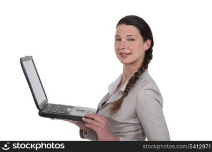 young woman standing with laptop